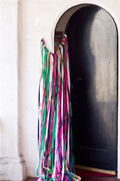 Hang streamers starting in the middle of the ceiling, going out to the tops of the walls. DIY Surprise Streamer Door for Birthdays