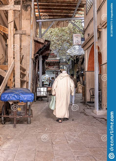 Rear View Of Old Man In Traditional Djellaba Walking On Street
