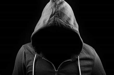 Unhappy guy in hood is sitting on cardboard on floor in abandoned building. Royalty Free Man In Black Hoodie Upset Pictures, Images ...