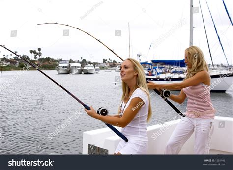 Two Sexy Young Blonds Fishing On A Yacht Hooked Up To Large Fish Stock