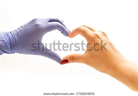 Latex Gloved Hand And Naked Hand Making A Heart