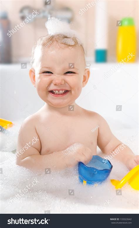 A bath hat shields your baby's face during bath time—that way, when you wash their hair, the water rolls backward rather than onto their face. Little Baby Girl Having Soapy Bath Stock Photo 133322642 ...