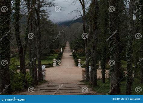 Idyllic Pathway Surrounded By Lush Forestry And Manicured Gardens Of A