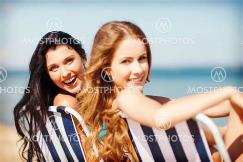 Girls Sunbathing On The Bea By Syda Productions Mostphotos