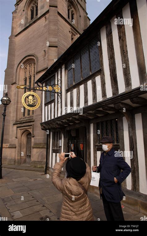 Tourists Taking A Photo Underneath A William Shakespeare Sign At The