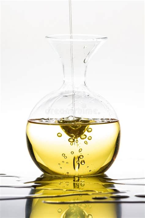 Pouring Olive Oil Into A Glass Bottle Stock Image Image Of Glassware
