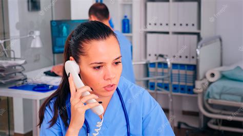 Premium Photo Healthcare Physician Answering Telephone In Hospital