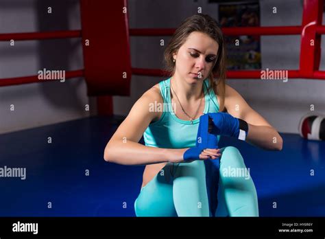 Female Athletic Boxer Preparing Bandages For Fight In Regular Boxing
