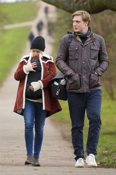 Emilia Clarke Cradles Her Newborn Godson For A Walk Around Hampstead