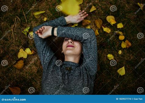 Beautiful Woman Enjoying Autumn In The Forest At Sunset Stock Photo