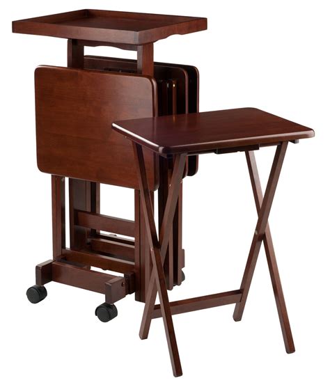 Made of 100% solid wood, this set includes 4 folding tables and a convenient storage stand, which is great for transportation. Val Walnut Tray Table Set - Snack Tables / TV Trays