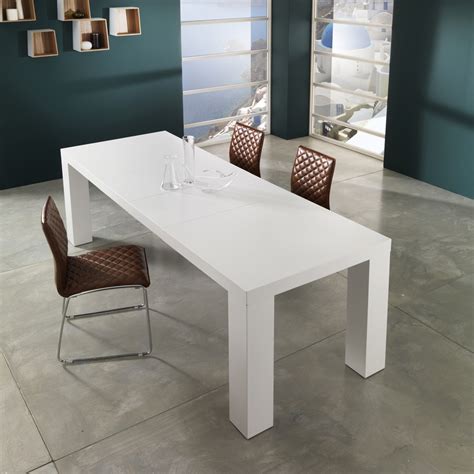 While the dining chairs have a classic look, with the combination of upholstery and polished wood, the soft lines and curves of the design give it a contemporary vibe. Modern design extendable dining table Demy, lacquered white finish