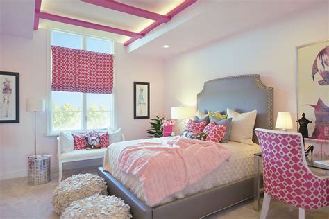 Lovely pink and gray teen girl's bedroom is furnished with pink and white faux fur stools placed on a gray rug in front of a gray upholstered bed dressed in white pintuck bedding lit by a white and gold light pendant. 25 Cool Kids' Bedrooms that Charm with Gorgeous Gray
