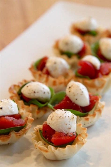 50 festive christmas appetizers that are so much better than the main course. tartlets stuffed with chopped tomato, fresh basil leaves ...