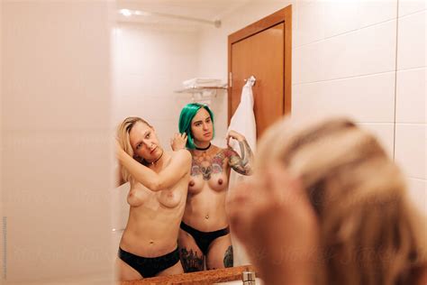 Topless Lesbian Women Looking At The Mirror By Stocksy Contributor Alexey Kuzma Stocksy