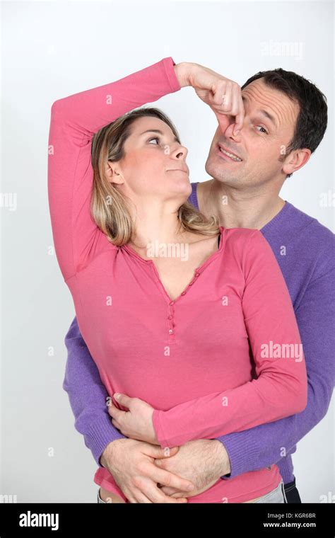 Woman Pinching Her Boyfriends Nose Stock Photo Alamy
