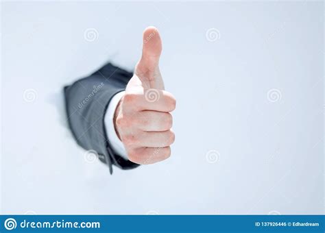 Businessman Breaks Through The Paper And Shows His Thumb Up Stock Photo