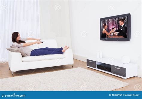 Woman Watching Tv While Relaxing On Sofa Stock Photo Image Of Movie