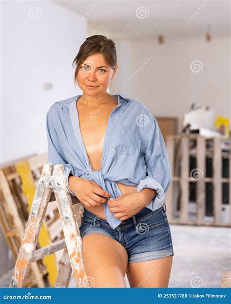 Portrait Of A Half Naked Girl In Short Shorts In Renovated Room Stock