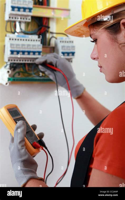 Female Electrician Checking The Wiring On A Fusebox Stock Photo Alamy