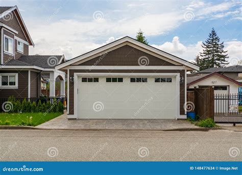 Detached Garage Of Residential House With Asphalt Road In Front Stock