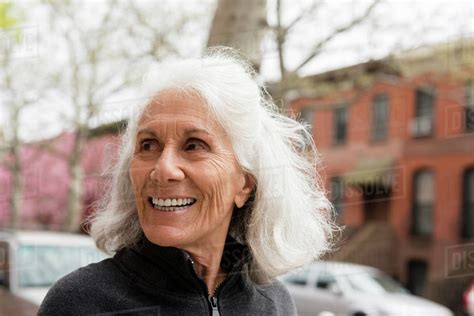 Smiling Older Woman Outdoors In City Stock Photo Dissolve
