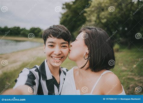 Happy Lesbian Couple Having Fun Kissing And Taking A Selfie Stock Image Image Of Phone Asian