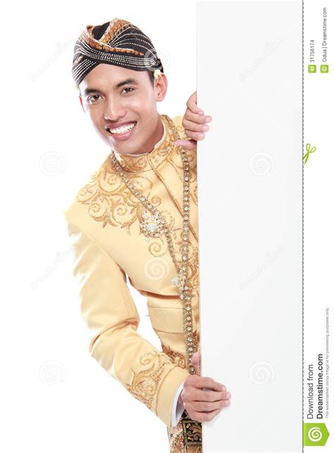 Man Wearing Traditional Dress Of Java Hiding Behind Blank White Stock