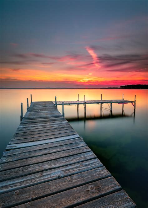 Brown Wooden Dock On Calm Water During Sunset Photo Free Water Image