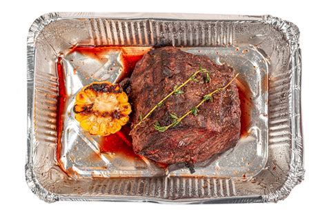 Fillet Mignon With Thyme Sprig And Grilled Corn In A Container Top