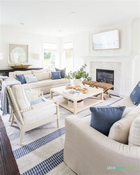 A Coastal Living Room With Linen Sofas White Spindle Chairs A Raffia