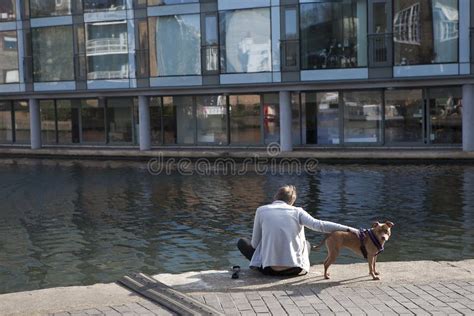 The Man With The Boxer Dog Sitting On The Regent Canal Waterfront
