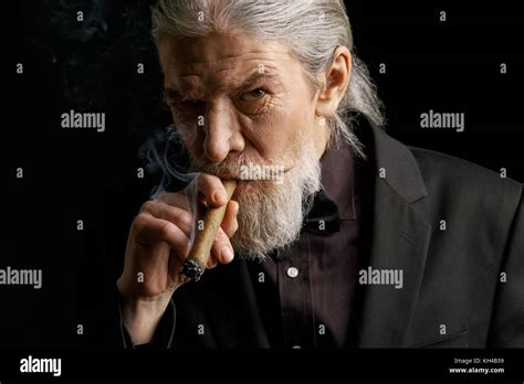 Stylish Old Man Smoking Cigar Aged Male In Black Suit In Studio Stock