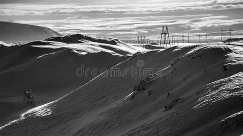 Grayscale Panoramic View Of A Snow Covered Mountain Slope With High