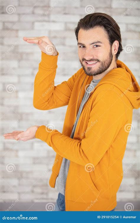 Young Man Looking At Hands Showing Something Huge Stock Photo Image