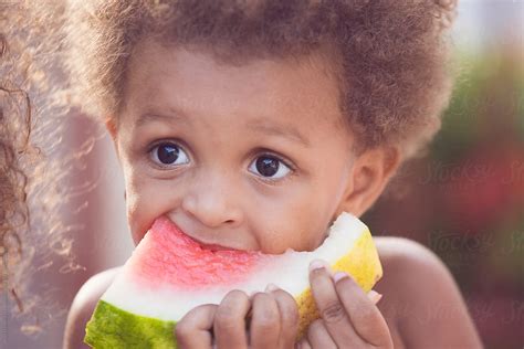 Young Child Eating Watermelon On A Hot Summer Day By Stocksy