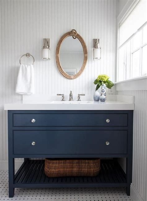Navy Blue Washstand With A White Quartz Countertop In A Kids Bathroom