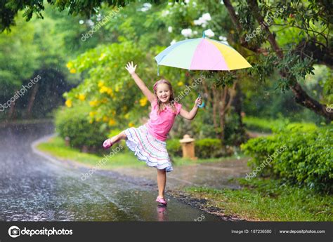 Kid With Umbrella Playing In Summer Rain — Stock Photo © Famveldman