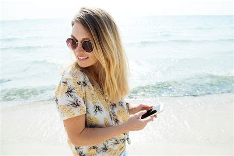 Free Photo Woman Wearing Sunglasses At The Beach Beach Sand Water