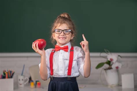 Premium Photo Portrait Of School Girl Nerd Student Hold Apple With