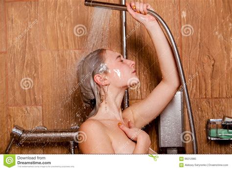 Beautiful Woman Standing At The Shower She Holds In Her Hand Showerhead Stock Image Image Of