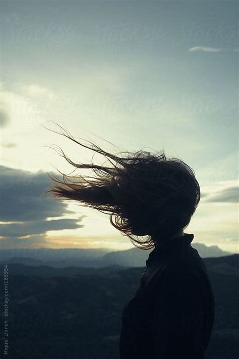 Girls Silhouette In Sunset With Her Long Hair Blowing In The Wind By