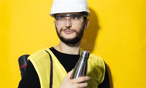 Portrait Of Young Builder Engineer With Tube Of Projects Wearing