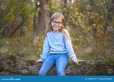 Portrait Of A Blonde Girl With Glasses Outdoors In The Park On The Autumn Park Background Stock
