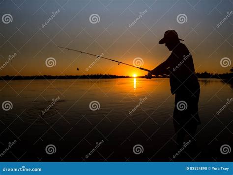 Man Fishing On A Lake From The Boat At Sunset Stock Photo Image Of