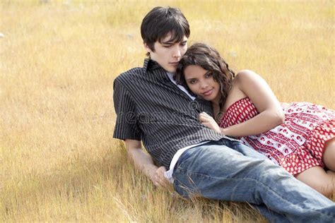 Young Teen Couple Reclining In Yellow Grass Stock Image Image Of Dress Teen 18879329