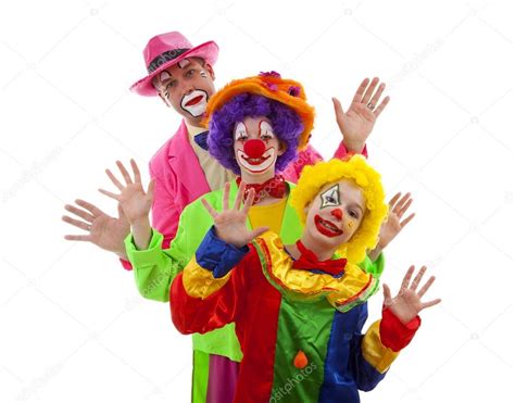 Three People Dressed Up As Colorful Funny Clowns Over White Back Stock