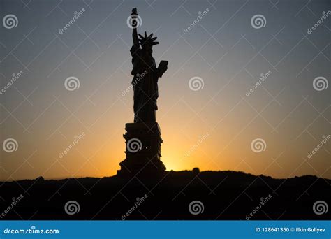 Statue Of Liberty On The Background Of Colorful Dawn Sky Stock Photo