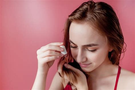 Premium Photo Young Girl Holds In Her Hand The Tips Of Her Hair And Her Right Hand Applies