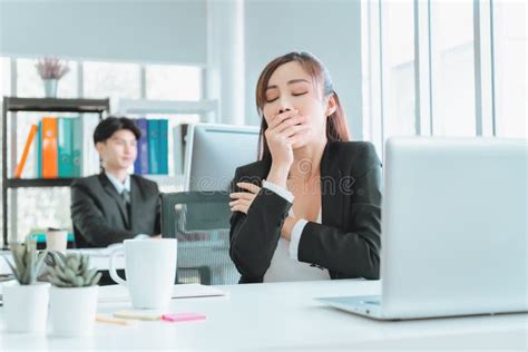 Sleepy Female Officer Yawning In Afternoon Office After Tired And